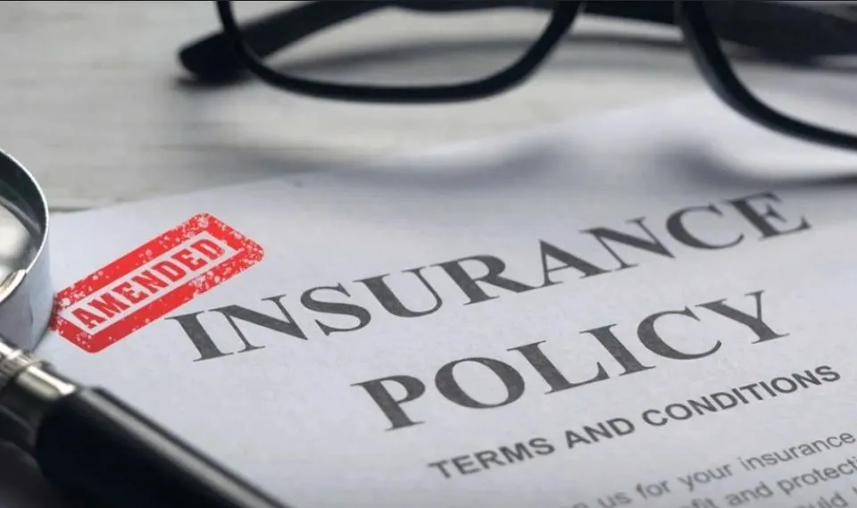 Insurance policy documents and a magnifying glass